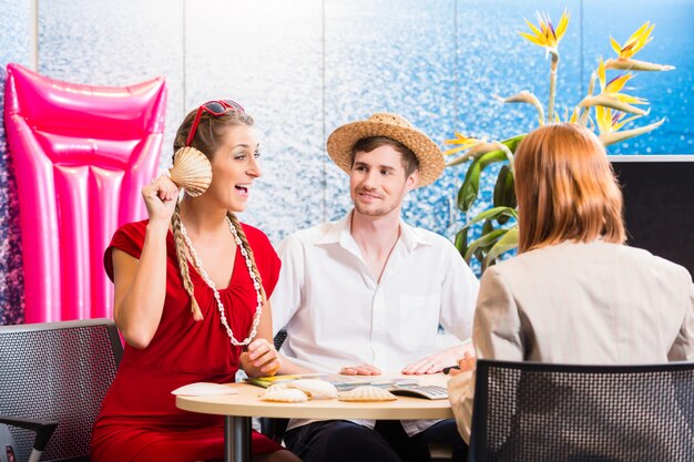 Woman in travel agency with shell listening