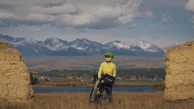 The woman travel on mixed terrain cycle touring with bikepacking