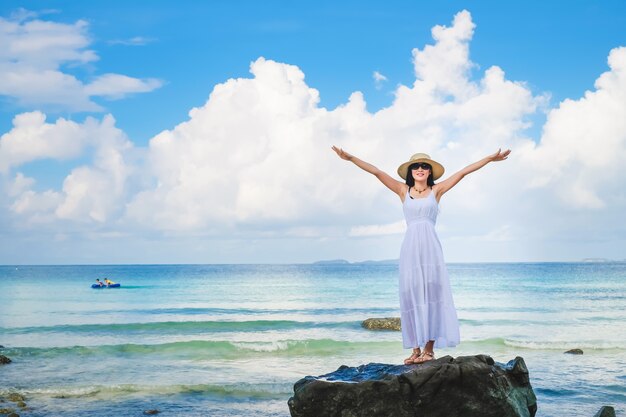 woman traveler enjoying for view of the beautiful sea on her holiday.