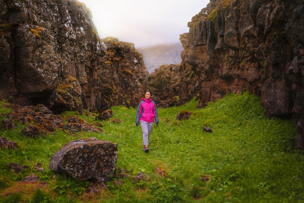 アイスランドの風景全体をハイキングする女性旅行者。