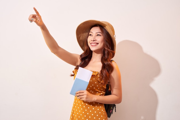 Woman traveler holding passport and finger pointing up