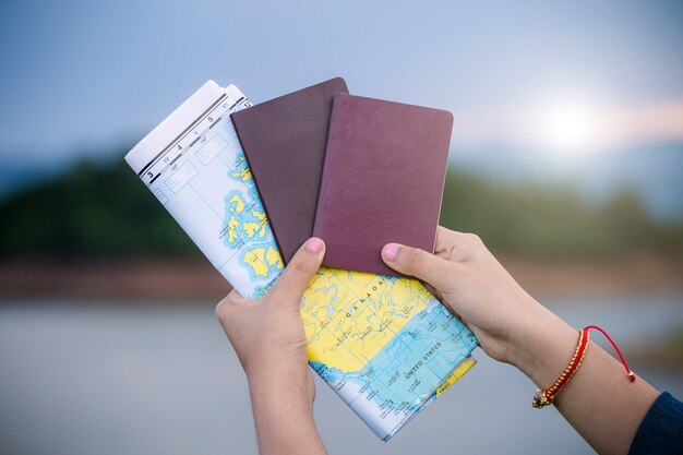 Woman traveler holding passport with map