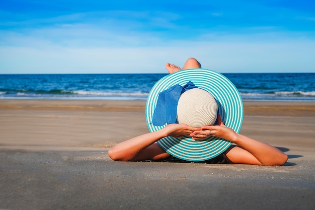 woman traveler in sexy swimming suit lie leisurely on the beach