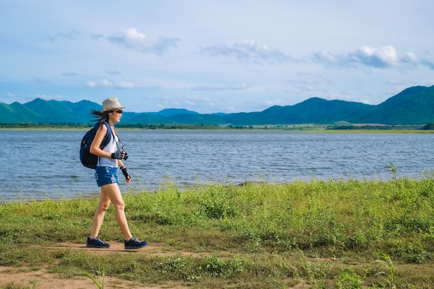 Фото Женщина путешественник стоит возле озера фон гора