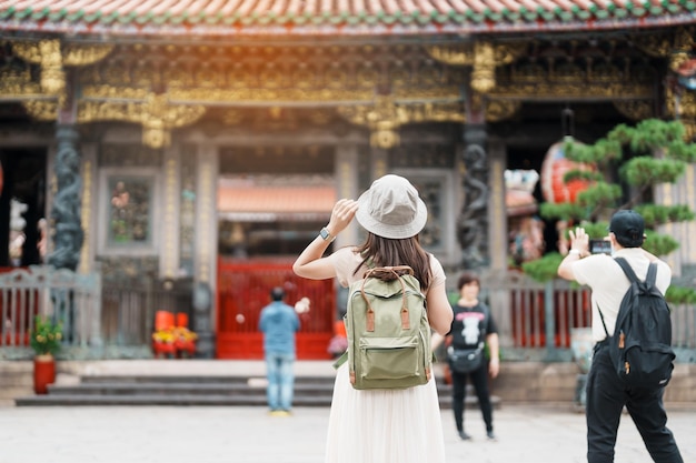 사진 대만을 방문하는 여성 여행자 longshan temple에서 모자 관광을 하는 관광객 wanhua district taipei city 랜드마크와 인기 있는 여행 및 휴가 개념에 있는 중국 민속 종교 사원