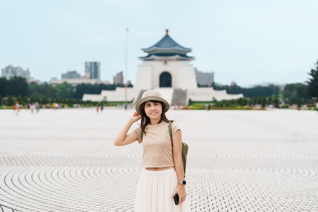 Woman traveler visiting in Taiwan Tourist with hat sightseeing in National Chiang Kai shek Memorial or Hall Freedom Square Taipei City landmark and popular attractions Asia Travel concept