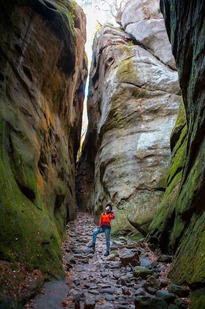 Woman traveler walking by trail in canyon