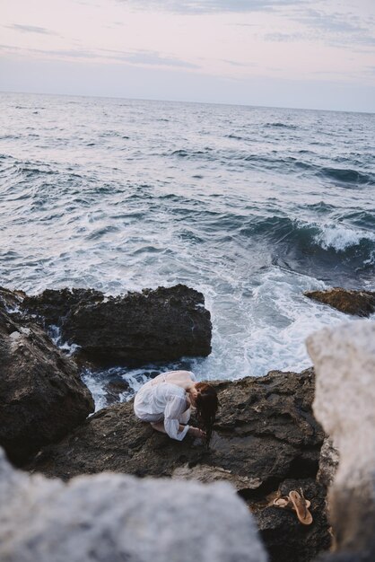 Woman traveler in white dress at the sea beach Lifestyle unaltered