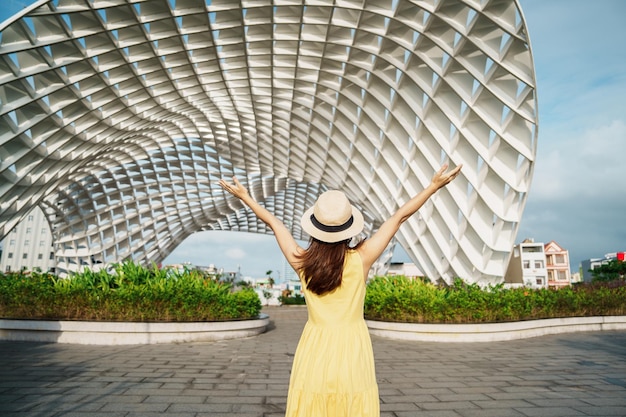 Woman traveler with yellow dress visiting in da nang city
tourist sightseeing the city building landmark and popular for
tourist attraction vietnam and southeast asia travel concept