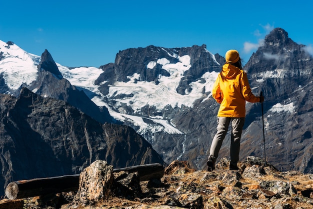 A woman traveling in the caucasus. mountain sports. athlete happy finish. mountain tourism. walking tour. the journey to the mountains. nordic walking among the mountains. copy space