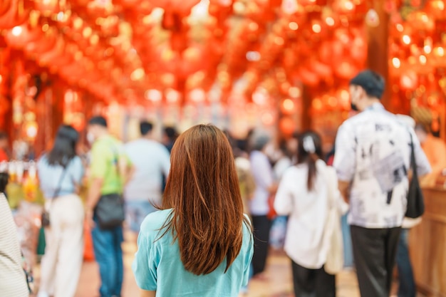 Woman traveling in Wat Mangkorn Kammalawas Leng Nuei Yee as Chinese temple Asian traveler visiting at Yaowarat road or Chinatown of Bangkok landmark and popular for tourist attractions in Thailand