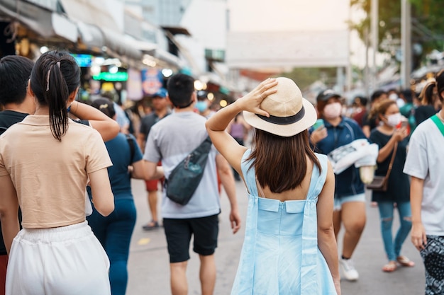 Woman traveling with hat asian traveler standing at chatuchak\
weekend market landmark and popular for tourist attractions in\
bangkok thailand travel in southeast asia concept