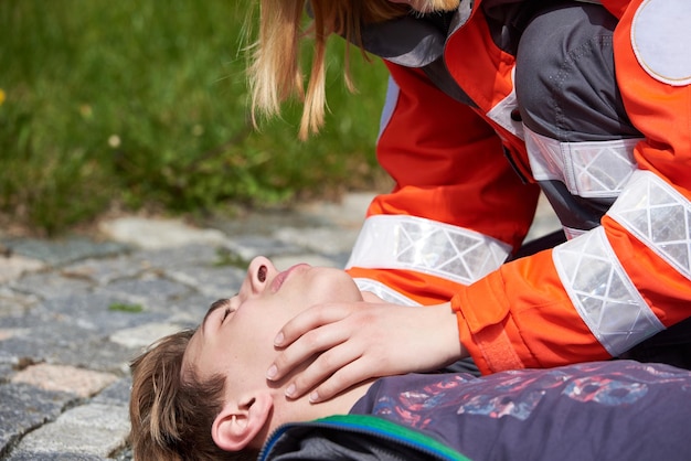 Woman trying therapy on patient lying on land