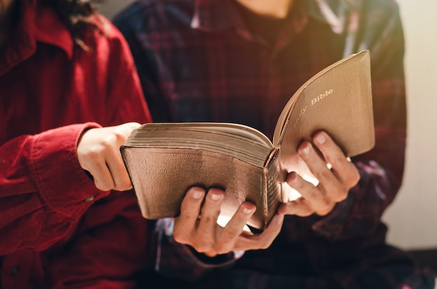 Una donna e due uomini stavano studiando e leggendo la bibbia. questo è l'amore cristiano