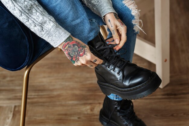 Woman tying her shoelaces on a chair