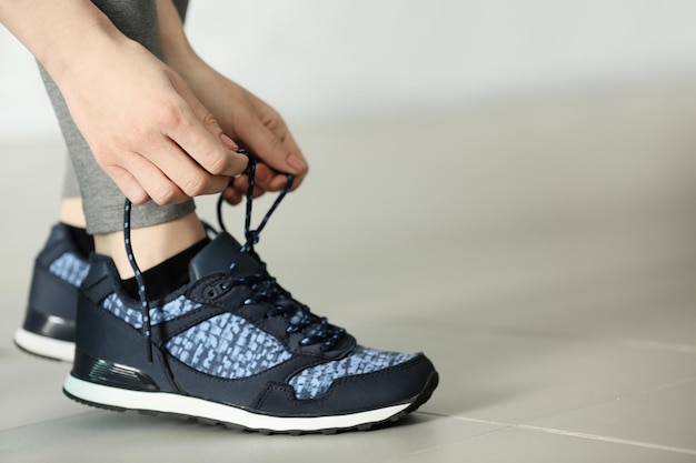 Woman tying up running shoe