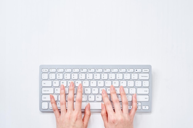 a woman typing on a keyboard