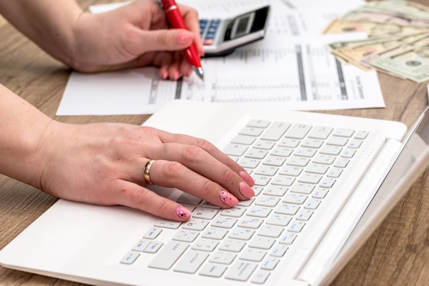 Woman typing on laptop, doing job