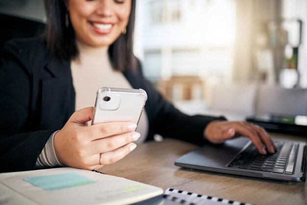 Woman typing and laptop in office with phone thinking and planning post schedule for blog on app Copywriting content creator website manager and computer with smile idea or social media at desk