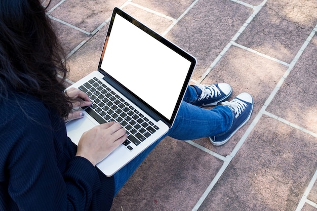 woman typing message on laptop