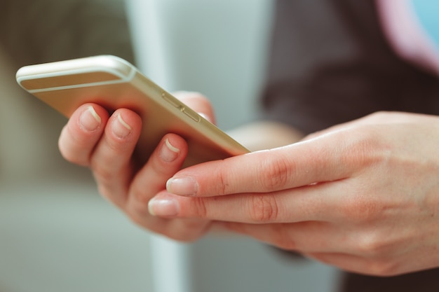 Woman typing write message on smart phone