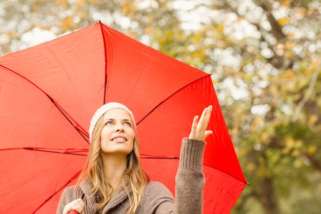 Photo woman under umbrella with hand raised