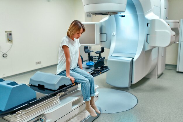 Woman undergoing radiation therapy for cancer in a modern\
cancer hospital