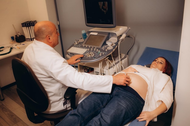 Woman undergoing ultrasound scan in clinic
