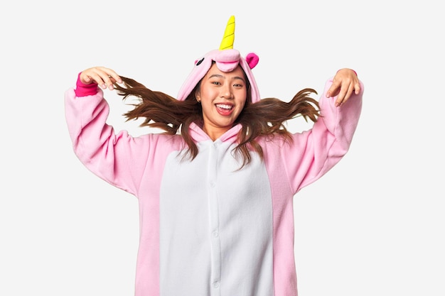 A woman in a unicorn costume is wearing a unicorn costume.