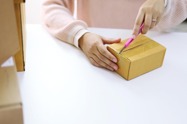 Woman unpacking unboxing after buying ordering online shopping at home