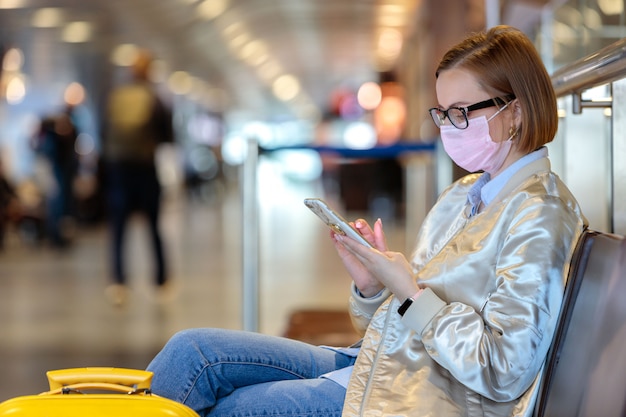 Woman upset over flight cancellation, writes message to family, sitting in almost empty airport terminal due to coronavirus pandemic