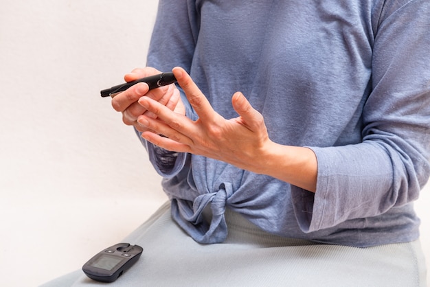 Woman use blood glucose detector