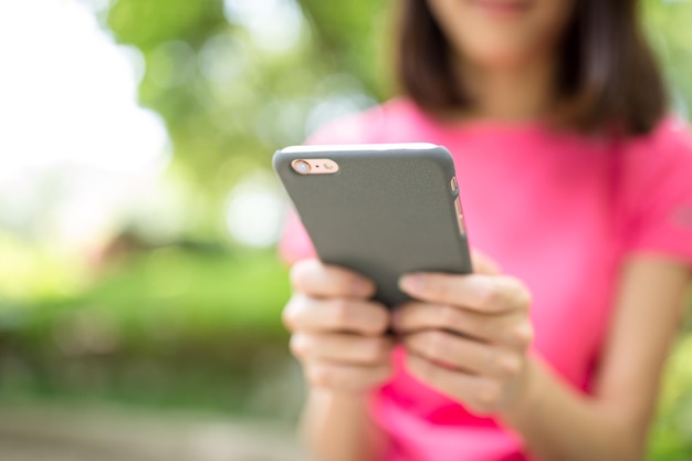 Woman use of cellphone at outdoor park