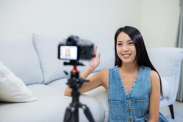 Woman use digital camera to take vlog at home