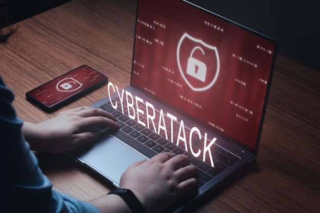 Woman use laptop with cyberatack warning on screen Cyber security data protection