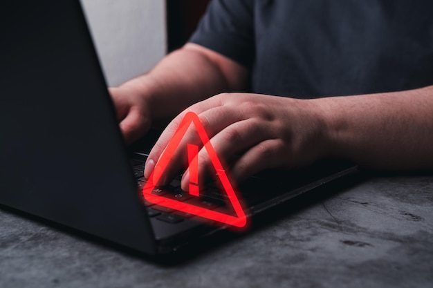 Woman use laptop with hologram warning sign for notification error Programmer and developer