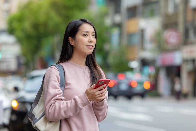 Woman use of mobile phone in city of Taipei