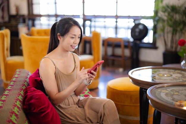 Woman use of mobile phone at coffee shop