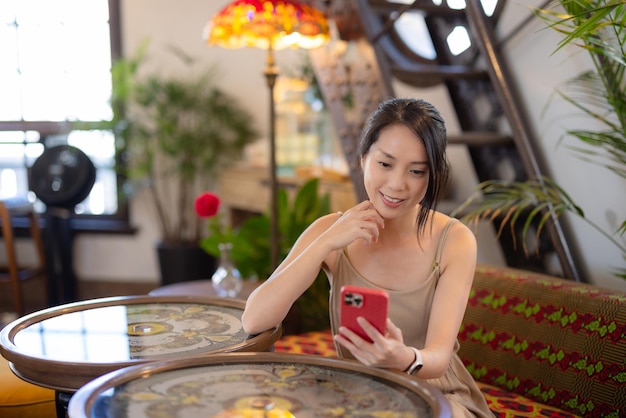 Woman use of mobile phone at coffee shop