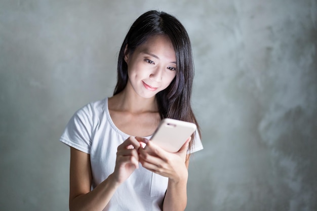 Photo woman use of mobile phone over grey background