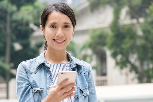 Женщина пользуется мобильным телефоном в Гонконге