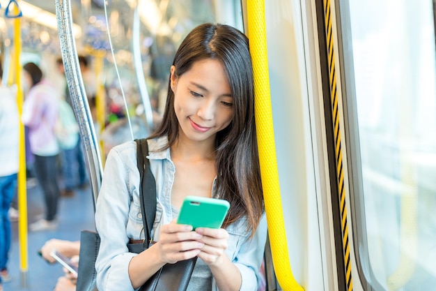 Woman use of mobile phone inside train