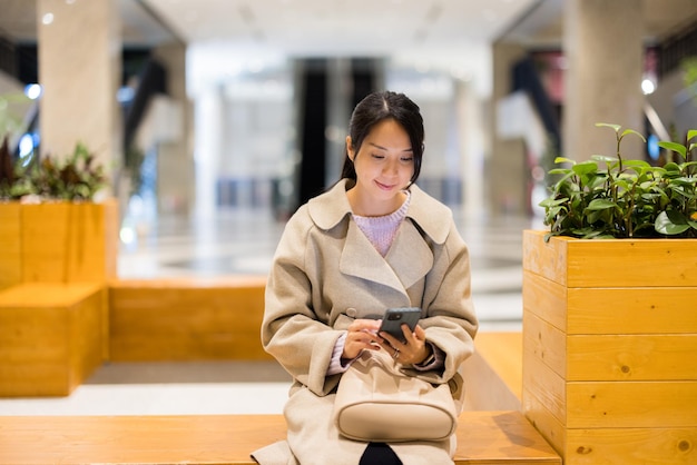 Woman use mobile phone in shopping center