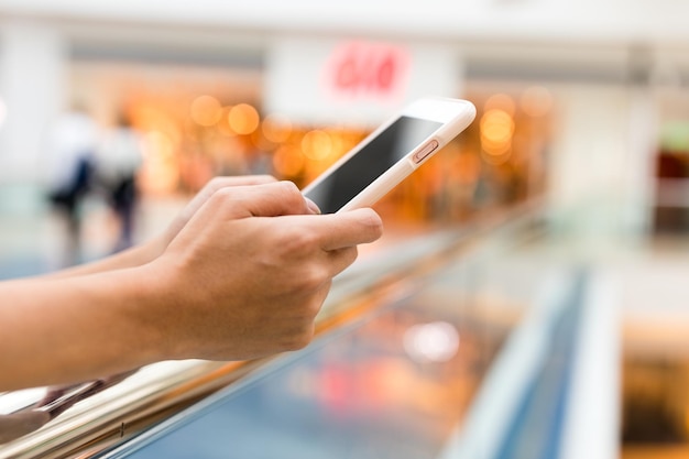 Woman use of mobile phone in shopping mall