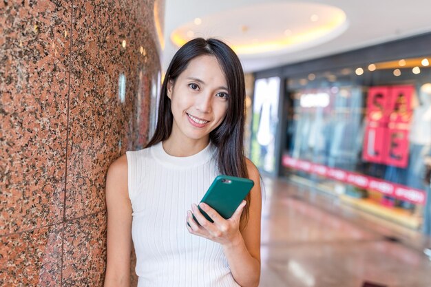 Woman use of mobile phone in shopping mall