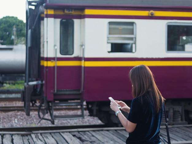 列車の駅で携帯電話の女性の使用