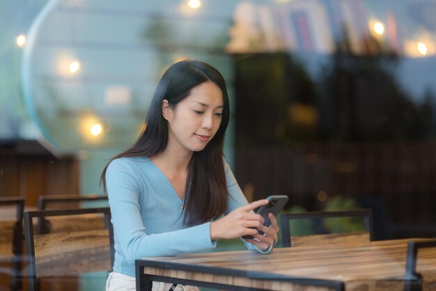 Woman use smart phone at coffee shop