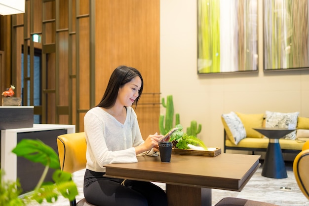 Woman use of smart phone in coffee shop