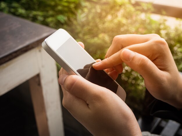 Woman use smartphone ,finger pointing screen on phone, girl holding white moblie on hand