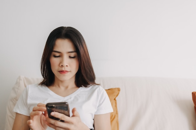 Woman use smartphone in the living room in the apartment